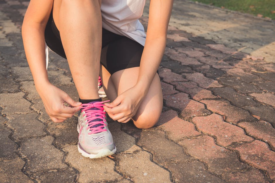 Picture of women tying the laces on her running shoes
