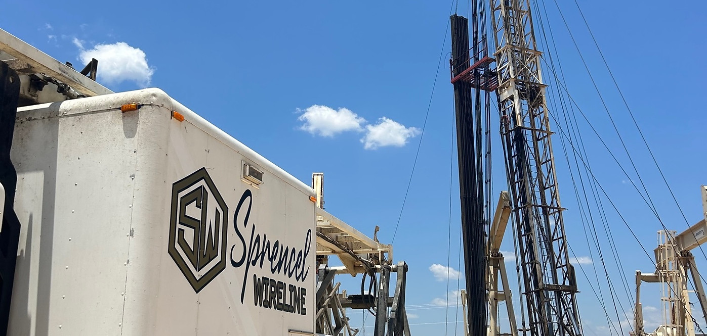 Sprencel Wireline Services truck and oil pump in background