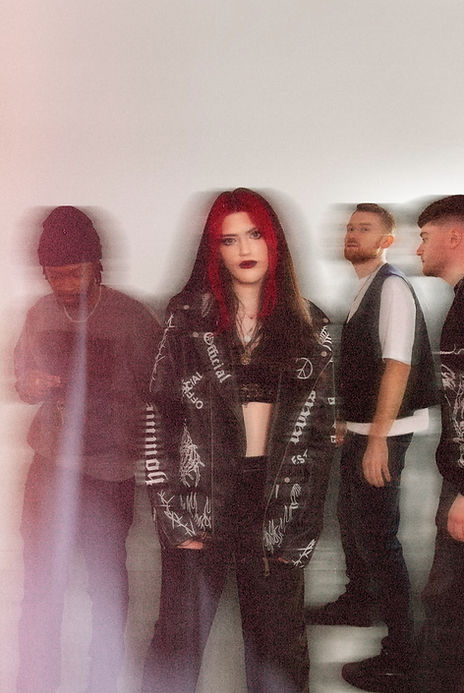 Alternative image edited with added blur, a red haired girl and 3 men all wearing black and white clothing.