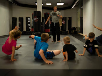 man teaching kids self defense 