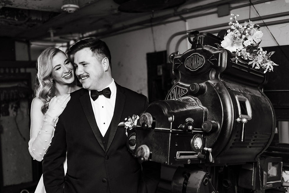 Photo of wedding couple next to vintage camera inside of the Orpheum Champaign in downtown Champaign, IL