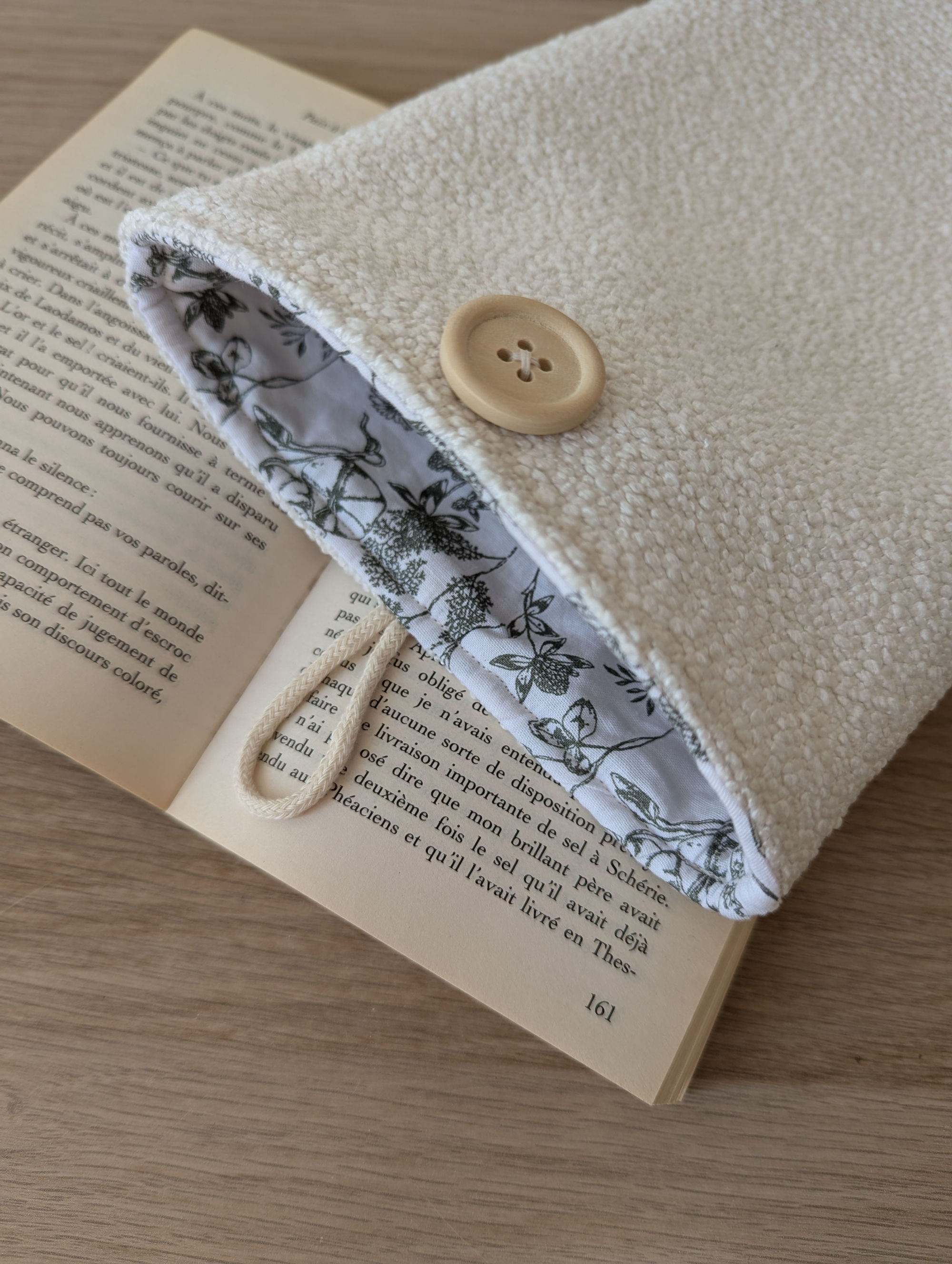 Pochette à livre posée sur un livre ouvert