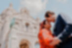 A romantic moment captured in Montmartre as a couple shares a tender embrace beneath the iconic Sacré-Cœur Basilica.