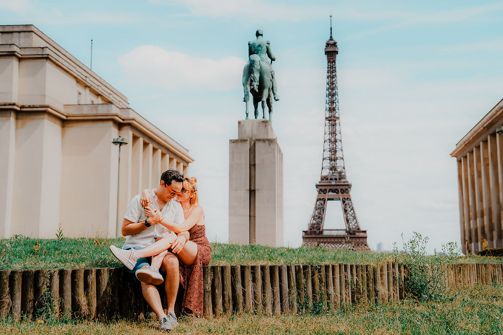 A couple shares a tender moment on the Trocadero, with the iconic Eiffel Tower standing majestically in the background under a clear blue sky. Photo by lovidovi.art