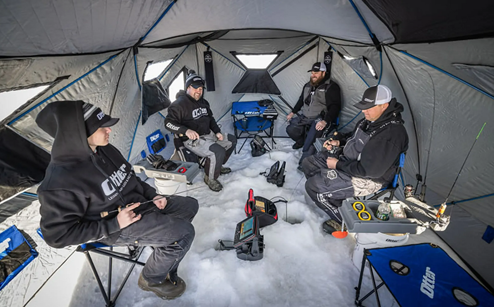 men inside an ice fishing tent