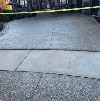Image: The driveway is made of asphalt, the sealant creates a glossy, protective layer on the driveway, enhancing its appearance and safeguarding it against weathering and cracks. 