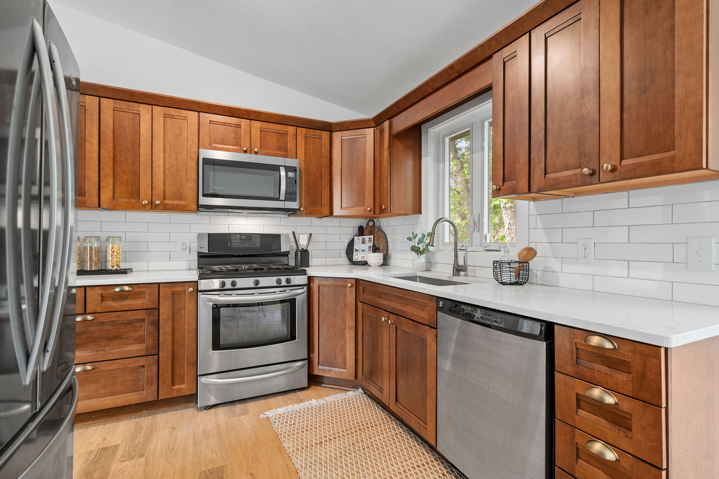 Kitchen with wood cabinets, stainless steel appliances, white backsplash