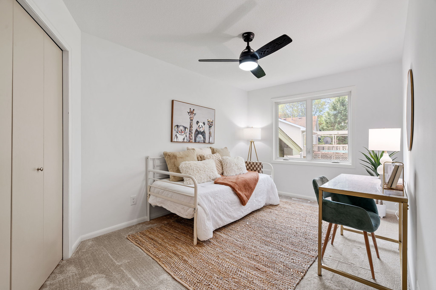 Kid's bedroom with daybed, animal art, and desk