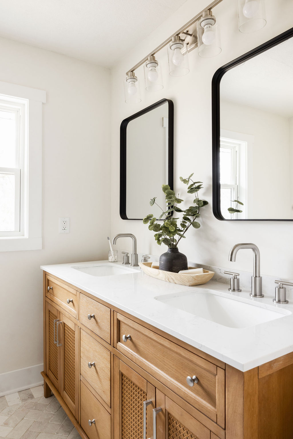 Modern double vanity with wooden cabinets and black mirrors