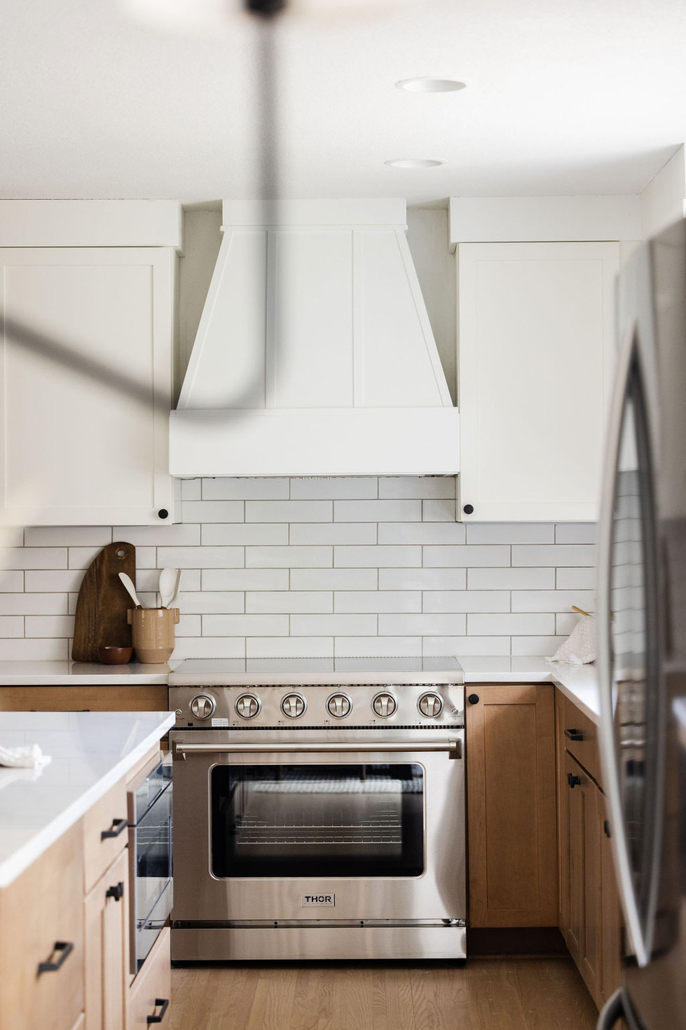 Modern kitchen with white subway tile, stainless steel range