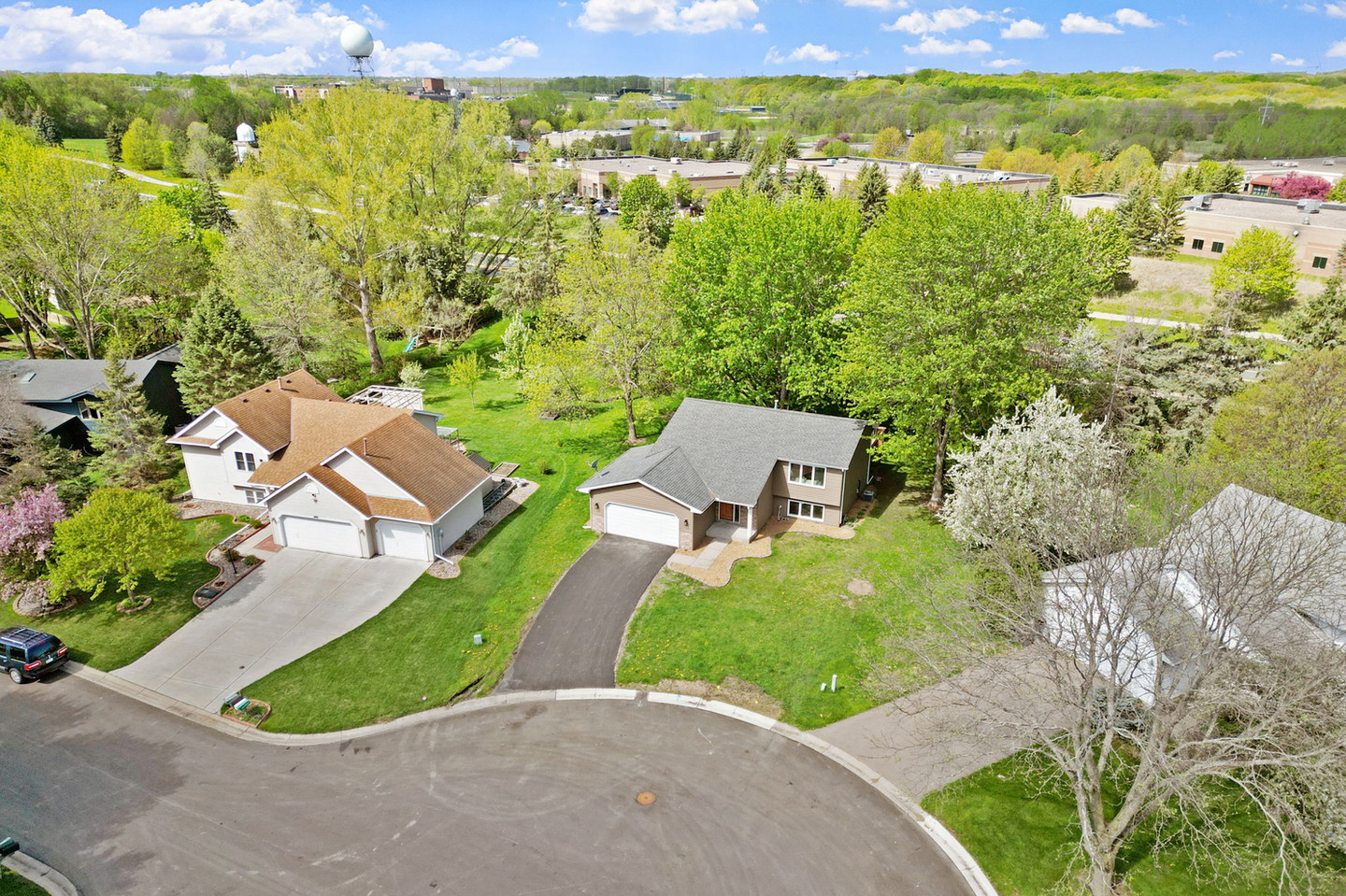Aerial view of two houses with green trees