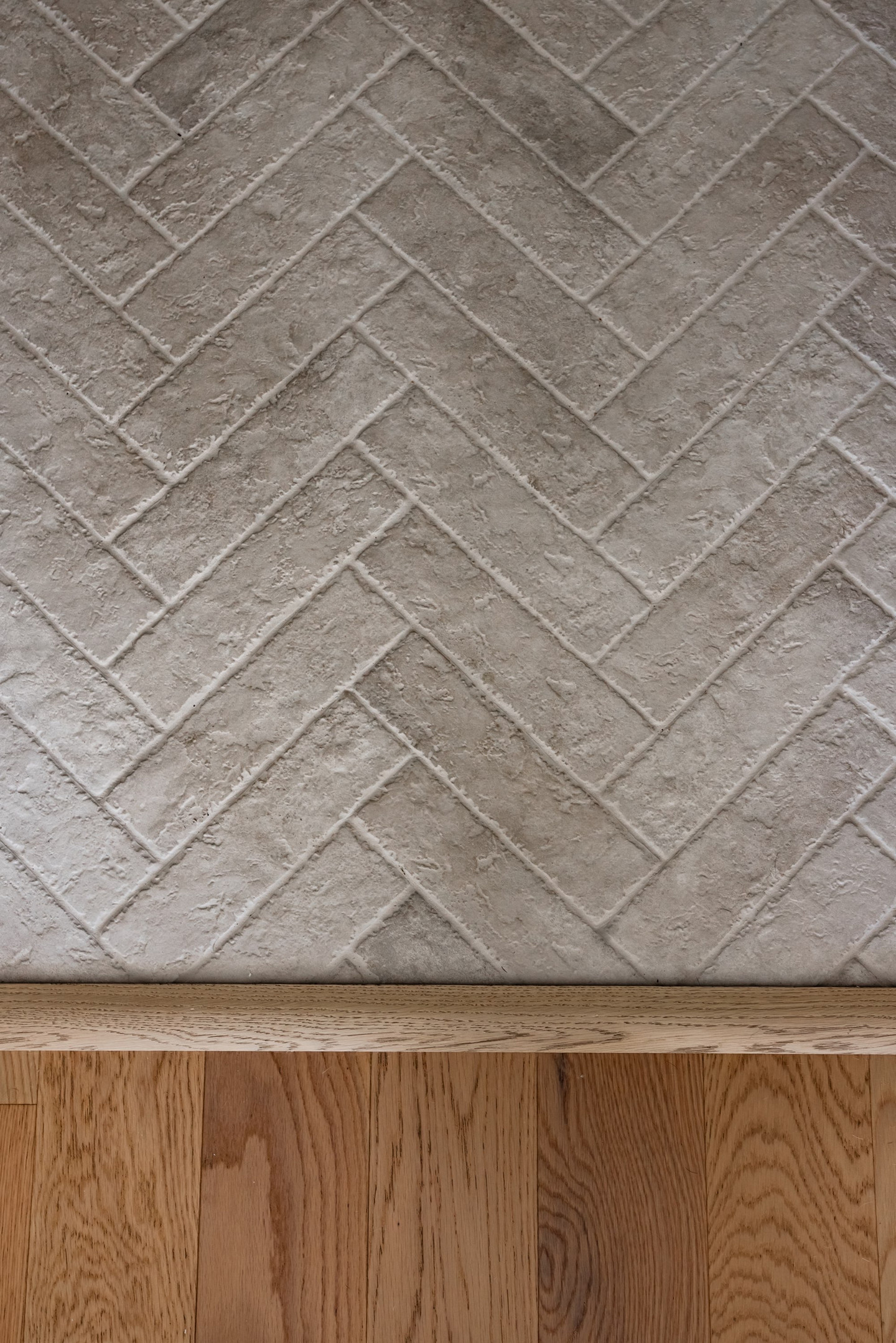 Herringbone tile pattern with wood edge