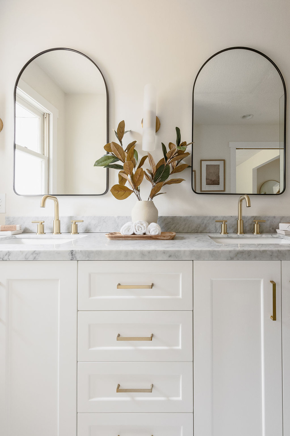5th Ave Revamp double vanity with marble counter, gold fixtures