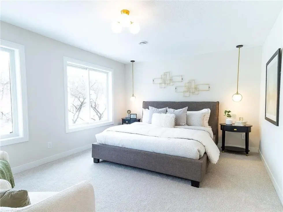 Styled master bedroom with mid century modern fixtures and styling with green accents