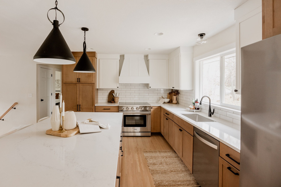 Bright modern kitchen with wood and white cabinets