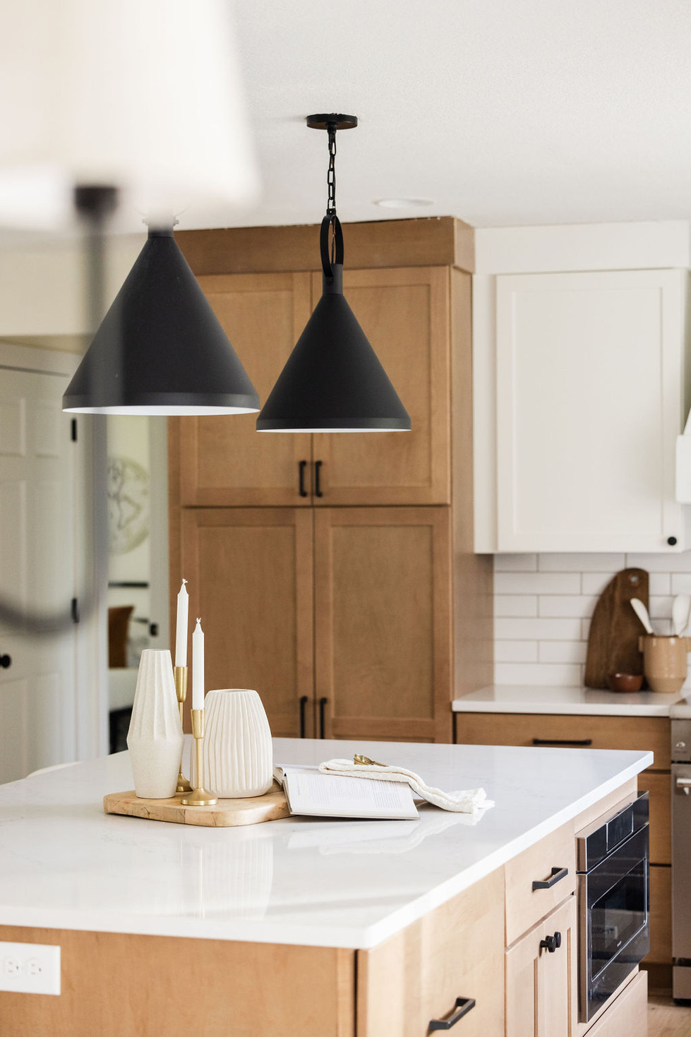 Modern kitchen island with black pendant lights
