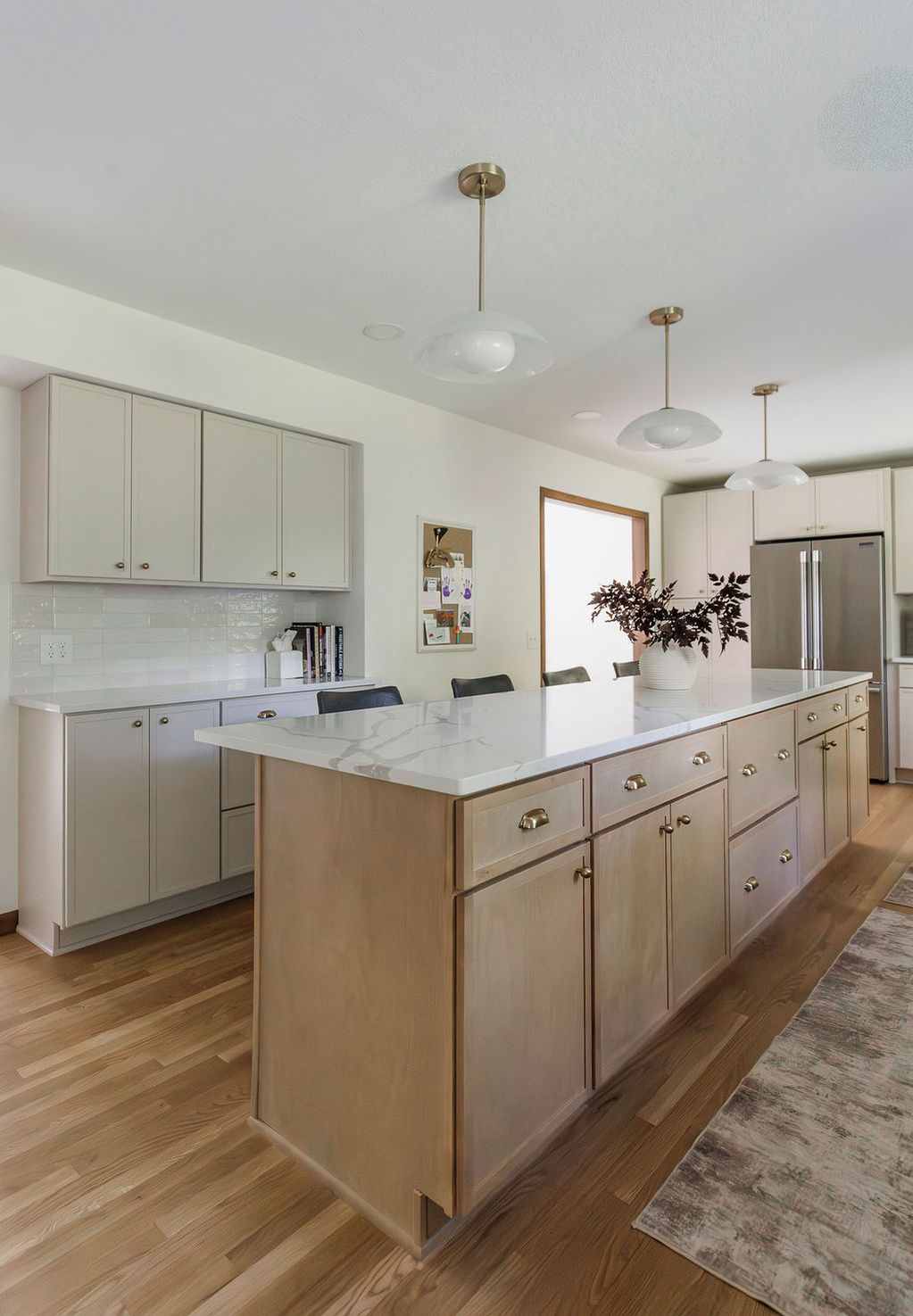 Remodeled kitchen with wooden island and light cabinets