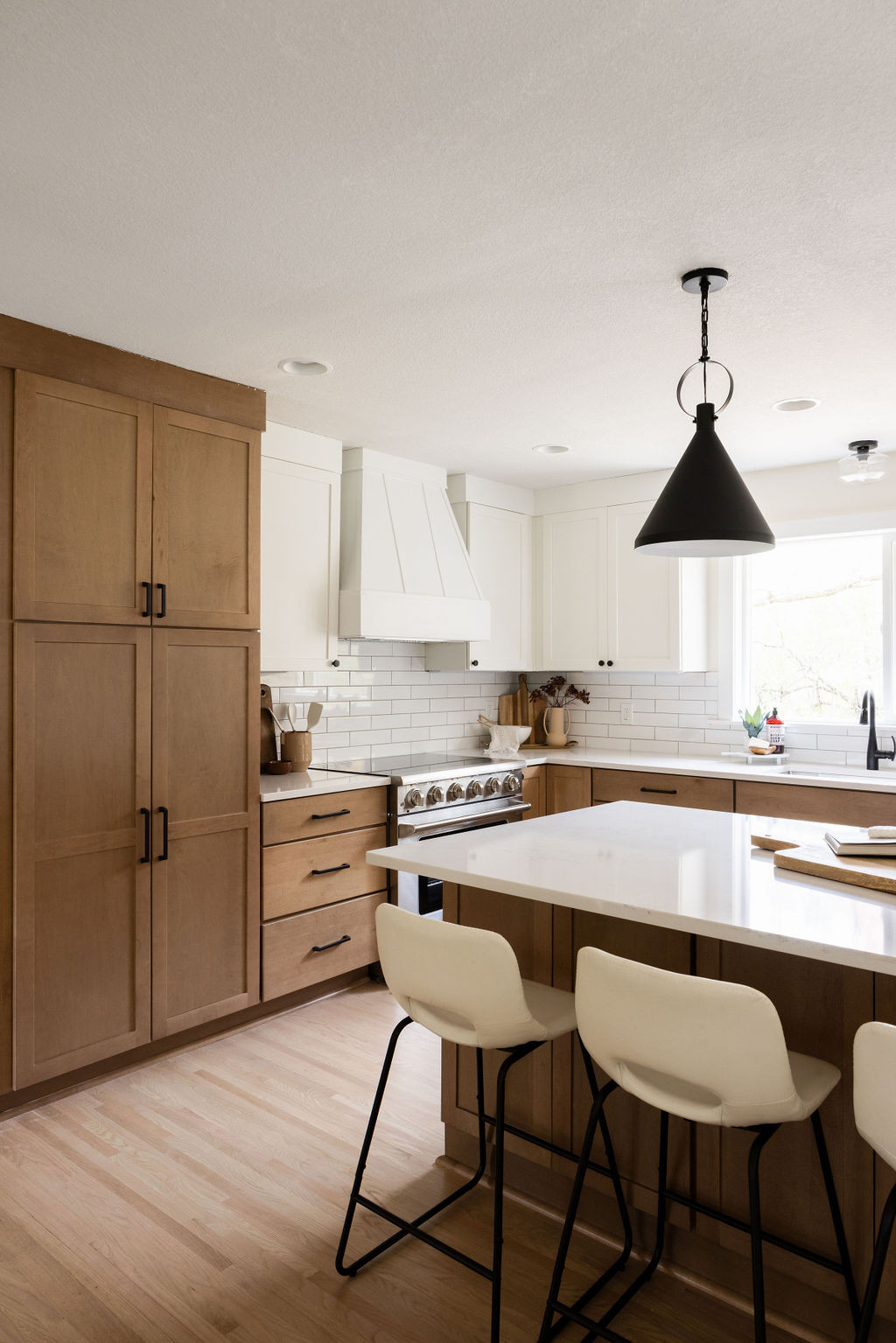 Modern kitchen with wood and white cabinets, island