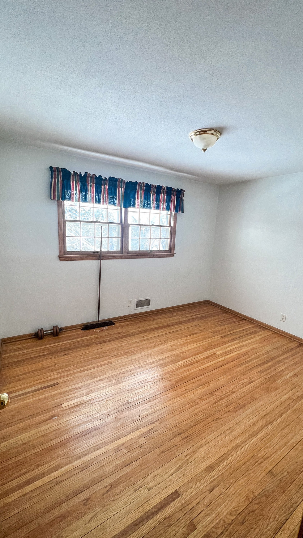Unfurnished room with hardwood floor and window