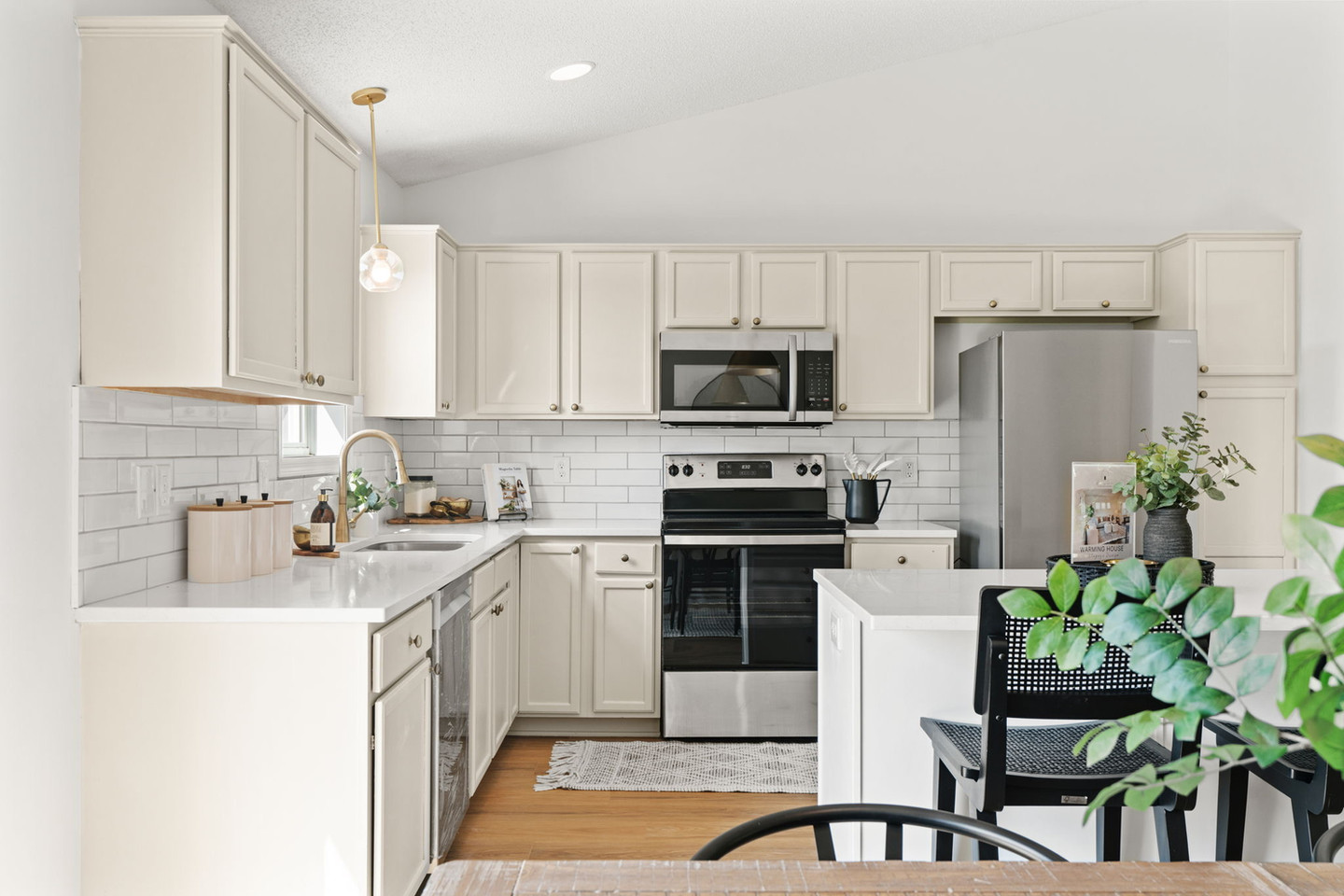 Modern kitchen with cream cabinets, white subway tile
