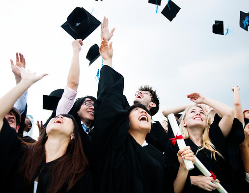 group-diverse-grads-throwing-caps-up-sky.jpg