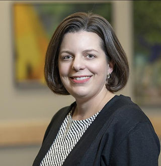 white woman in a black and white dress with black cardigan