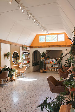Modern and boho hair salon interior featuring premium hair care products at The Mount Hair Collective in the Bay of Plenty