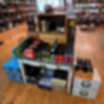 Shelves of beverages with beer displays in a store, Ale Jail.