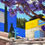 Miniatura: Architectural block color contrasts Jacaranda purple blooms SMA