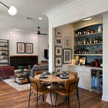 dining home bar curated art gallery wall fireplace modern lighting white walls