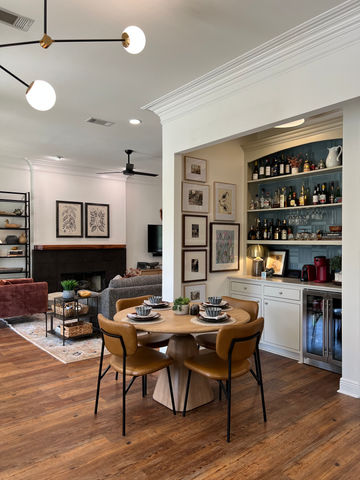 dining home bar curated art gallery wall fireplace modern lighting white walls