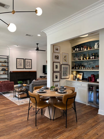 dining home bar curated art gallery wall fireplace modern lighting white walls