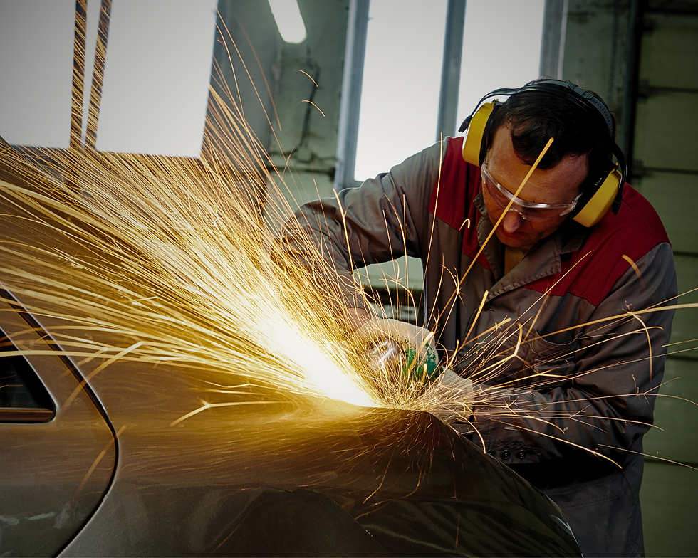 Technician grinding car body for collision repair