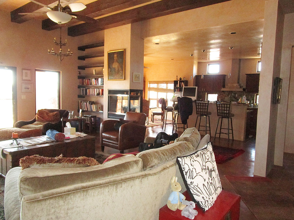 Contemporary pueblo-style living room with owner posessions prior to home staging services.