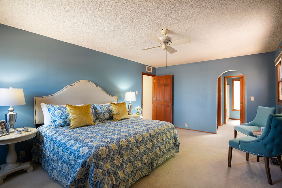 Blue master bedroom styled with matching linens and home decor.