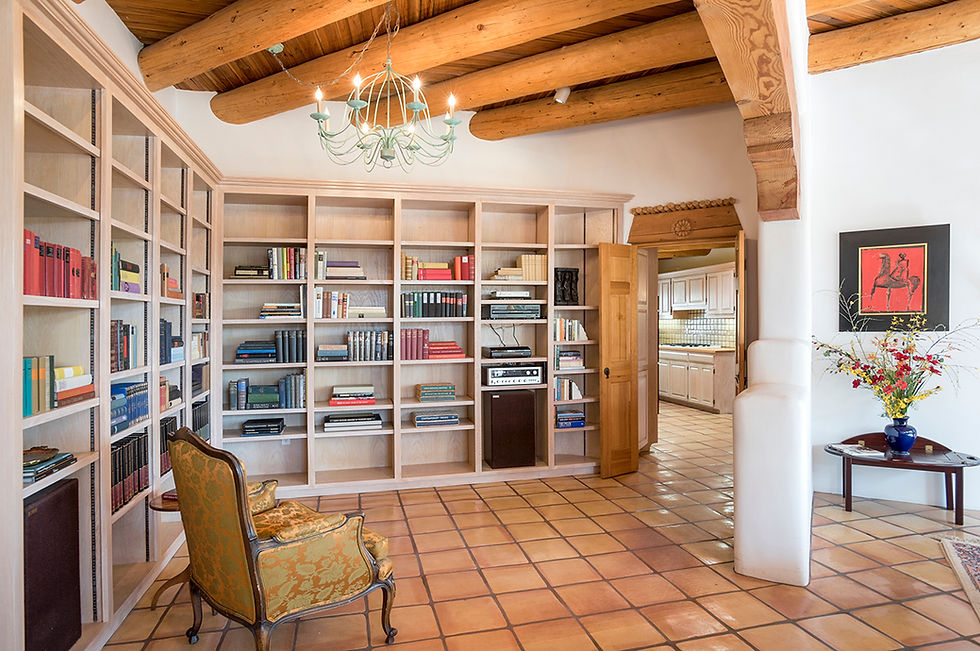 Library alcove without a dark rug and every shelf filled looks larger and more inviting