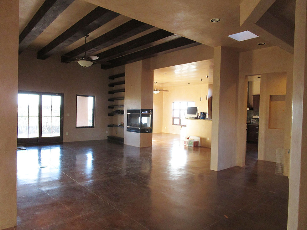 Vacant open concept living room space looking into dining room.