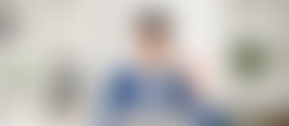 man waving in front of laptop during meeting