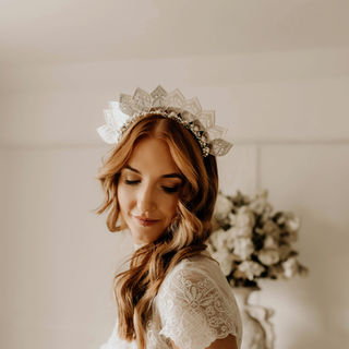 bride wears a bold statement silver leaf headpiece with crystal detail