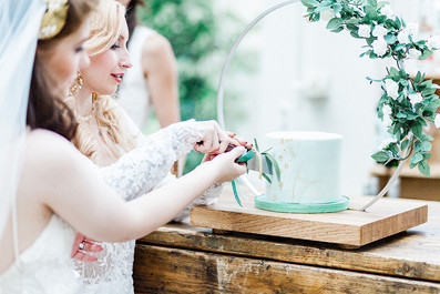 Brides cutting wedding cake