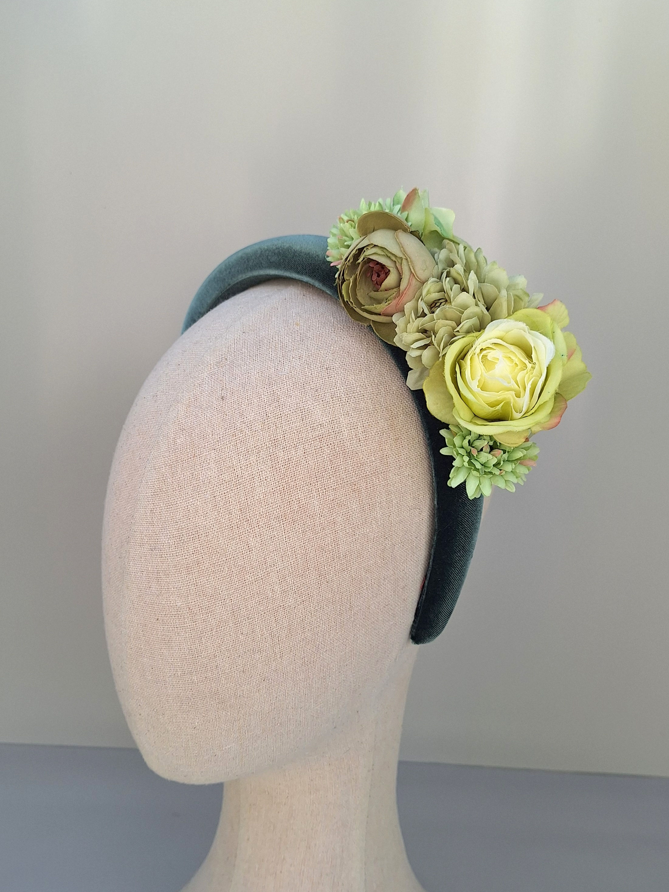 Stylish green floral headband on a mannequin, a modern alternative to fascinators for wedding guests and race day glam
