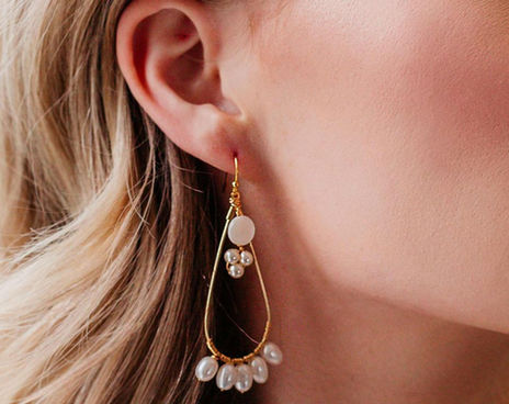 Woman wearing teardrop pearl earrings