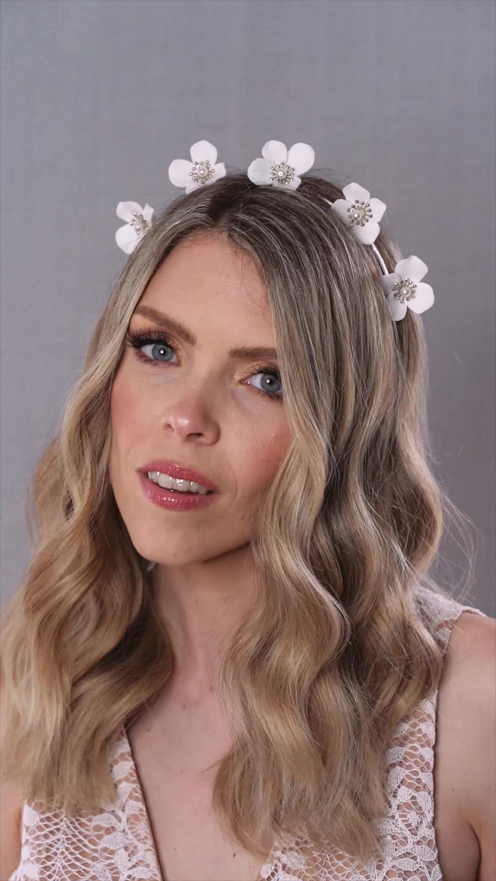 Thumbnail: bride wears boho floral hair accessory with sunburst stamens and shimmering Preciosa pearls.