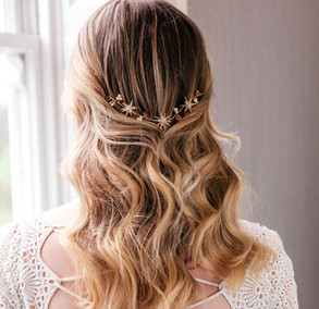 Bride wearing stars and moon celestial gold wedding headpiece