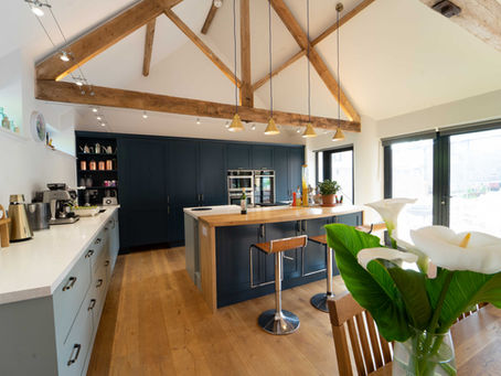Two tone slate blue and light teal kitchen in a modernised barn conversion
