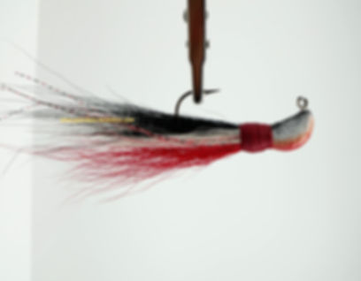 Side view of Black White and Red - Banana Bucktail Jig