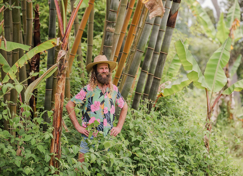 Ryan, founder of Hamakua Sanctuary, standing among bamboo representing mindful stewardship.