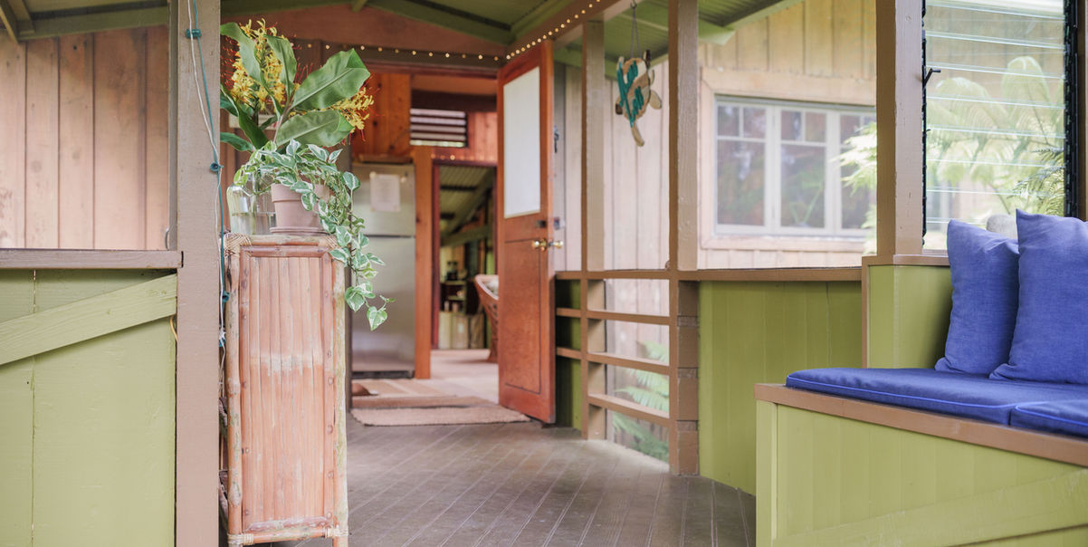 Open hallway with green walls and tropical plants at Hamakua Sanctuary.