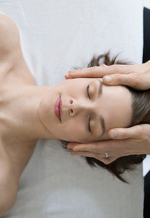 Woman receiving facial massage
