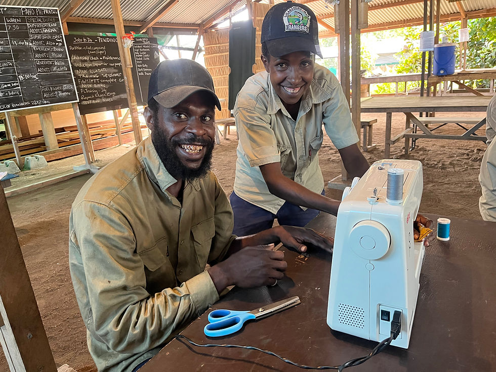 Learning new skills - Senior Ranger Melinta Gabitu teaching fellow Ranger Daniel Giali how